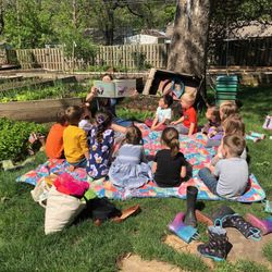 Little Sprouts Montessori - Story time in our outdoor classroom