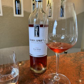 Flora Springs Winery - a glass of rose wine and a bottle of wine - Wineries Near Me - Saint Helena, California