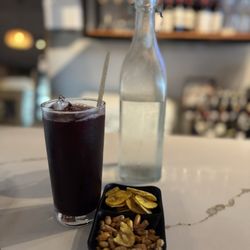 Taipa Peruvian Restaurant- Coral Gables - A little chicha morada ( non alcoholic drink made out of blue corn ) appetizer with some water