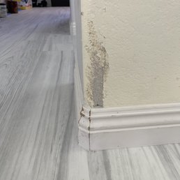 Destroyed drywall from pulling baseboards, they did not repair it properly