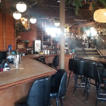 Joy Hill - Lower area with community table and couches - Bars Near Me - Denver, Colorado Joy Hill - Lower area with community table and couches - Bars Near Me - Denver, Colorado