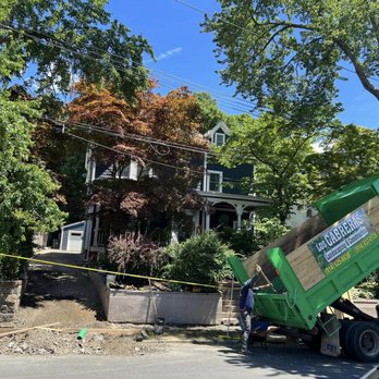 Los Cabreras Construction - a green dump truck in front of a house - General Contractors Near Me - Ossining, New York Los Cabreras Construction - a green dump truck in front of a house - General Contractors Near Me - Ossining, New York