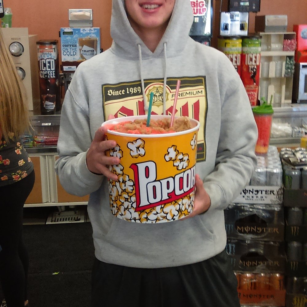 7-Eleven - a young man holding a box of popcorn - Convenience Stores Near Me - Wildomar, California 7-Eleven - a young man holding a box of popcorn - Convenience Stores Near Me - Wildomar, California