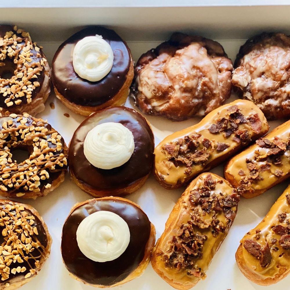 Donuts To Go - Left to right.. snickers, Boston crime, apple fritters, and maple bacon - Donuts Near Me - Sanford, Florida