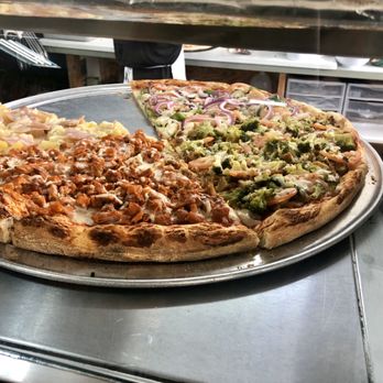 Tony's Pizzeria - a pizza with a slice taken out of it - Italian Near Me - Passaic, New Jersey