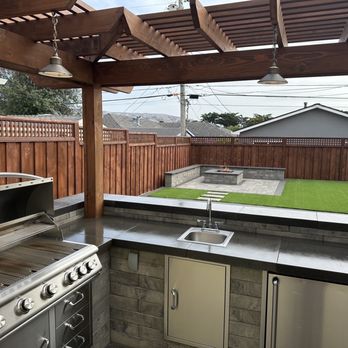 Signature Landscapes - an outdoor kitchen with a grill and sink - Landscaping Near Me Signature Landscapes - an outdoor kitchen with a grill and sink - Landscaping Near Me