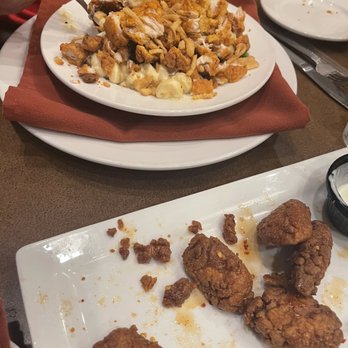 Tavern on South - Chicken bites for an appetizer. Honey on top and ranch dressing on the side. Mac & cheese with chicken in the background. - Bars Near Me - Indianapolis, Indiana Tavern on South - Chicken bites for an appetizer. Honey on top and ranch dressing on the side. Mac & cheese with chicken in the background. - Bars Near Me - Indianapolis, Indiana