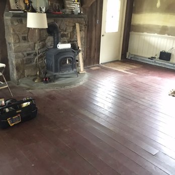 Zach Cole Flooring - a living room with a wood burning stove - General Contractors Near Me - Scranton, Pennsylvania