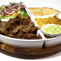 Gyros & Kabobs - Gyro Plate -
Rice, Gyro, Specialty Sauces, Tzatziki, Salad, Chutney, and Pita