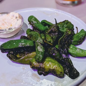 Kalimotxo - a plate of green peppers and a bowl of dip - Basque Near Me - Austin, Texas Kalimotxo - a plate of green peppers and a bowl of dip - Basque Near Me - Austin, Texas