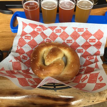 Harpoon Brewery - UFO flight with pretzel and dipping sauce. Buffalo bleu cheese on the left and garlic herb butter on the right. - Breweries Near Me - Boston, Massachusetts