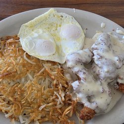 Juniors Cafe - Fried eggs and hash browns covered with sausage gravy.
