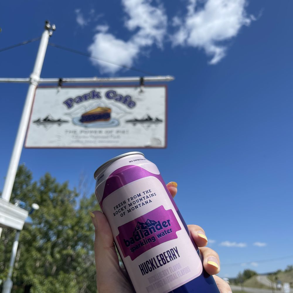The sign outside for Park Cafe and the can of sparkling huckleberry water The sign outside for Park Cafe and the can of sparkling huckleberry water