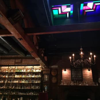 Multnomah Whiskey Library - One of many floor to ceiling shelves of whiskey and booze, and the gorgeous decor. - Lounges Near Me - Portland, Oregon