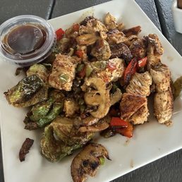 Grit & Grind Grilled chicken, mushrooms, onions, peppers, Brussels sprouts and Asian dressing.