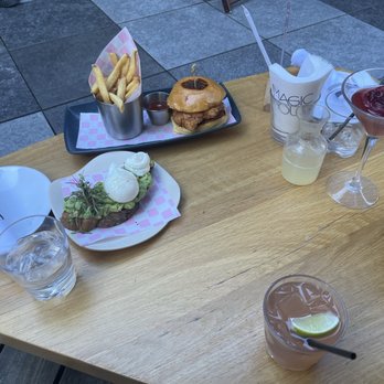 Magic Hour Rooftop Bar & Lounge - Avocado Toast with the Winter White Spritz. Chicken Sandwich with Fries and the Moira Rose - Lounges Near Me - New York, New York
