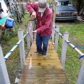 Tony Harrison Handyman & Remodeling - a man washing a dog - Handyman Near Me Tony Harrison Handyman & Remodeling - a man washing a dog - Handyman Near Me
