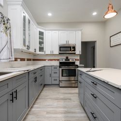 Promise Land Construction - Full kitchen renovation - quartz countertops, shaker cabinets, tile backsplash with copper accents & vinyl plank flooring.