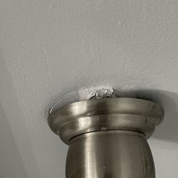 Synergy Builders - Toilet paper holder pulling out of the wall due to latex paint allowing moisture penetration.