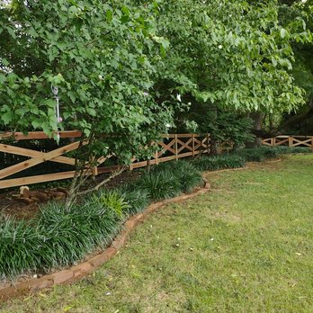 River's Landscape Design - a garden with a wooden fence - Landscaping Near Me River's Landscape Design - a garden with a wooden fence - Landscaping Near Me