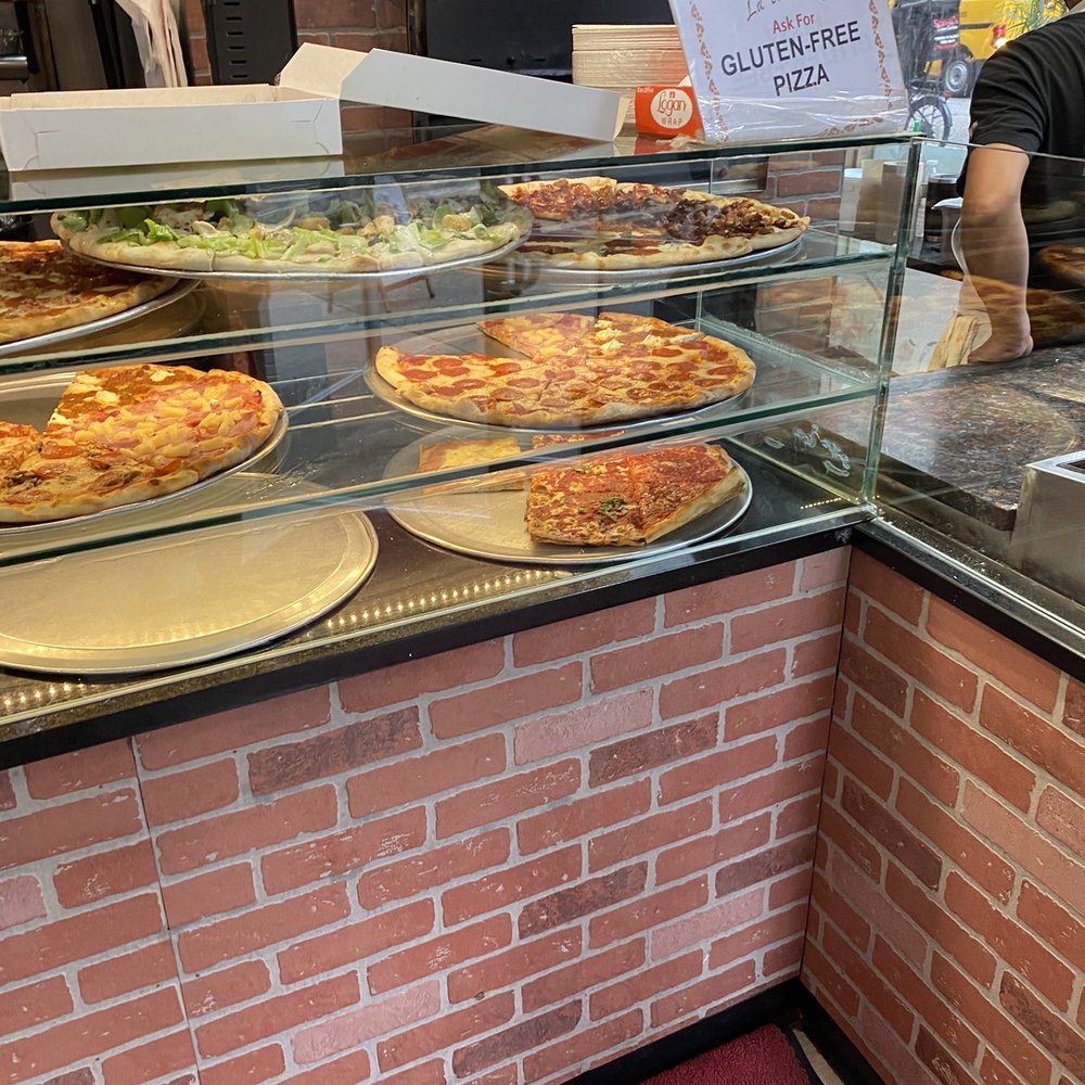 La Trattoria - a pizza counter with a variety of pizzas - Pizza Near Me - New York, New York La Trattoria - a pizza counter with a variety of pizzas - Pizza Near Me - New York, New York