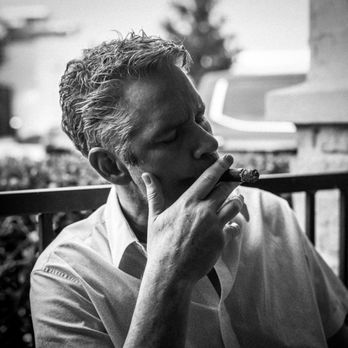 Rock and Rye - Don Marsh enjoying a cigar on the patio. - Cocktail Bars Near Me - San Antonio, Texas
