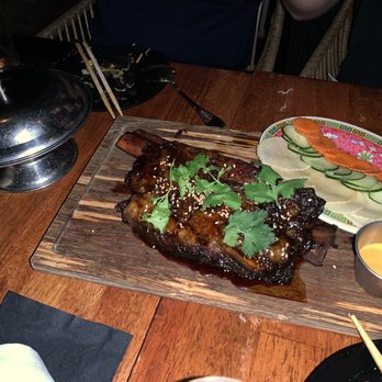 Phuc Yea - Smoked Bone In Short Rib (pho spiced hickory smoked beef short rib w/ fish sauce caramel, sesame, herbage - MP $64 + buns $7 + pickles $7) - Vietnamese Near Me - Miami, Florida Phuc Yea - Smoked Bone In Short Rib (pho spiced hickory smoked beef short rib w/ fish sauce caramel, sesame, herbage - MP $64 + buns $7 + pickles $7) - Vietnamese Near Me - Miami, Florida