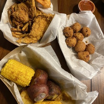 Surf’s Up - Potatoes and corn, hush puppies, chicken wings, and fried catfish. - Seafood Near Me - AURORA, Illinois