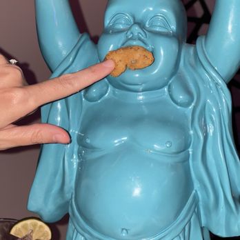 Deluxe Fun Dining - Feeding baby Buddha - Bars Near Me - Charlotte, North Carolina