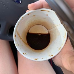 a person holding a cup of coffee