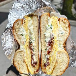a person holding a sandwich