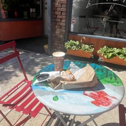 2 tables set out front 1 in sun and 1 in shade of a tree