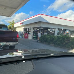 a view of a gas station from inside a car