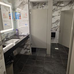 Ladies room. Baby wipes and diaper mat on counter near sink.