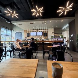 Sitting, sipping coffee with a beautiful, esthetically designed coffee shop. Sitting, sipping coffee with a beautiful, esthetically designed coffee shop.