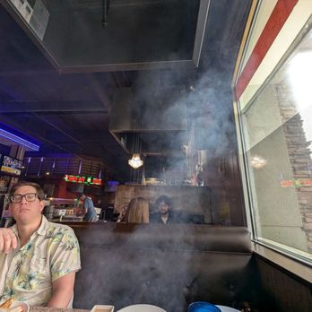 Love BBQ - The smoke - my son is on the right side of the booth trying to duck the smoke! - Korean Near Me - Palmdale, California