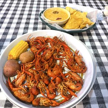 Flying Fish - Crawfish boil in front, Alligator Queso & Chips in back - Seafood Near Me - Little Rock, Arkansas Flying Fish - Crawfish boil in front, Alligator Queso & Chips in back - Seafood Near Me - Little Rock, Arkansas