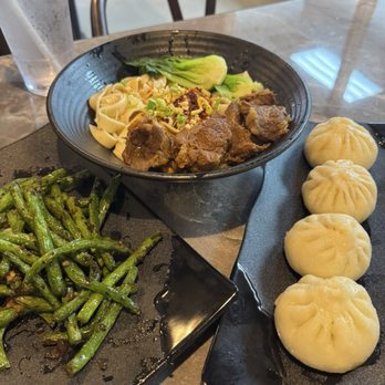 Juicy Dumpling - Stir-fried green beans, spicy beef brisket noodles (dry), pan-fried pork buns. - Asian Fusion Near Me - Charlotte, North Carolina Juicy Dumpling - Stir-fried green beans, spicy beef brisket noodles (dry), pan-fried pork buns. - Asian Fusion Near Me - Charlotte, North Carolina