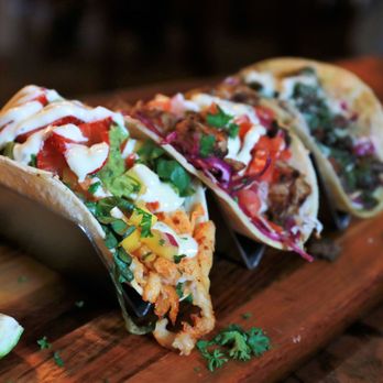 Ghost Taco - three tacos on a wooden cutting board - Tacos Near Me - Amityville, New York Ghost Taco - three tacos on a wooden cutting board - Tacos Near Me - Amityville, New York