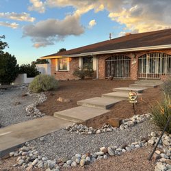Zapata Outdoor Services - AFTER: Reorganized existing gravel and added a new contrasting color to create a clean, cohesive look enhancing the home's natural beauty.