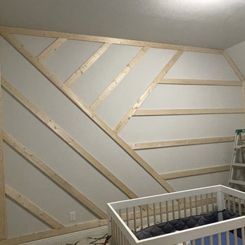 Elite Home Repairs - a baby's room with a crib - Painters Near Me