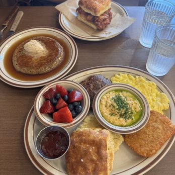 Kinfolk - A breakfast platter with eggs, grits, sausage, hash brown, and a site of fruit and jam. Oatmeal Pancakes! Chicken biscuit. - Coffee & Tea Near Me - Memphis, Tennessee