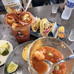 Modelo michelada, shrimp coctel, skirt steak tacos Modelo michelada, shrimp coctel, skirt steak tacos