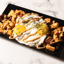 Maya Lounge - Andouille Sausage Hash. Roasted Potatoes, Red and Green Bell Peppers, Andouille Sausage topped with cajun sauce and eggs.