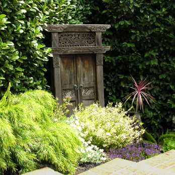 Leigh Designs - A carved Indonesian door and lush planting are wonderful diversions along this garden pathway. - Landscaping Near Me Leigh Designs - A carved Indonesian door and lush planting are wonderful diversions along this garden pathway. - Landscaping Near Me