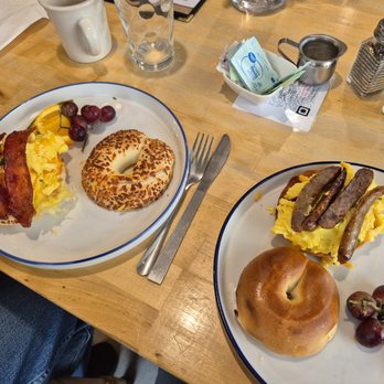 Riverwalk Park Inn Cafe - Fresh bagel breakfast sandwiches. One with bacon, the other with sausage - Breakfast & Brunch Near Me - Chelan, Washington Riverwalk Park Inn Cafe - Fresh bagel breakfast sandwiches. One with bacon, the other with sausage - Breakfast & Brunch Near Me - Chelan, Washington