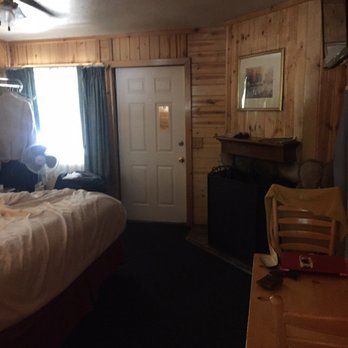 Big Bear Frontier - Dark room with cheap drapes, filthy carpet, and saggy bed. - Hotels Near Me - Big Bear Lake, California