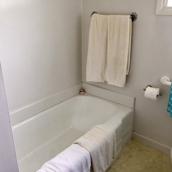 Olberding Construction - The old cast iron tub and yellowed vinyl flooring has seen better days. - General Contractors Near Me - Westminster, California