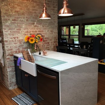 Elegant Stone - a kitchen island with a sink and dishwasher - General Contractors Near Me - Fresno, California