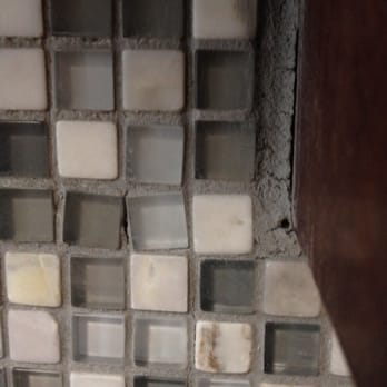 Paragon Construction Services - This is the view of the backsplash from the sink, tiles are not straight and grout is extremely thick at the edges. - General Contractors Near Me